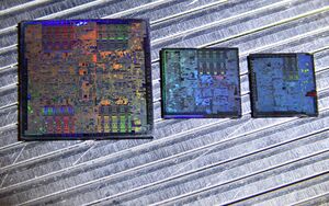 Three GPU dies are lined up in a row, from largest to smallest, left to right: the Nvidia G80, then the G84, then the G86. The internals of the dies are visible.